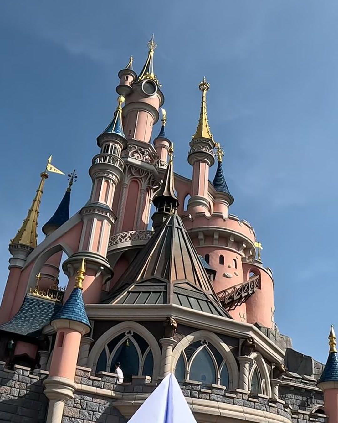 The Disneyland Paris castle under a blue sky